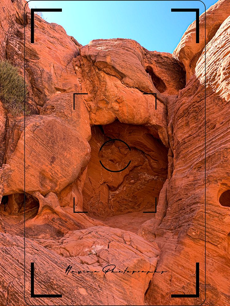 a hole in the walls of a mountain in Valley of Fire National Park