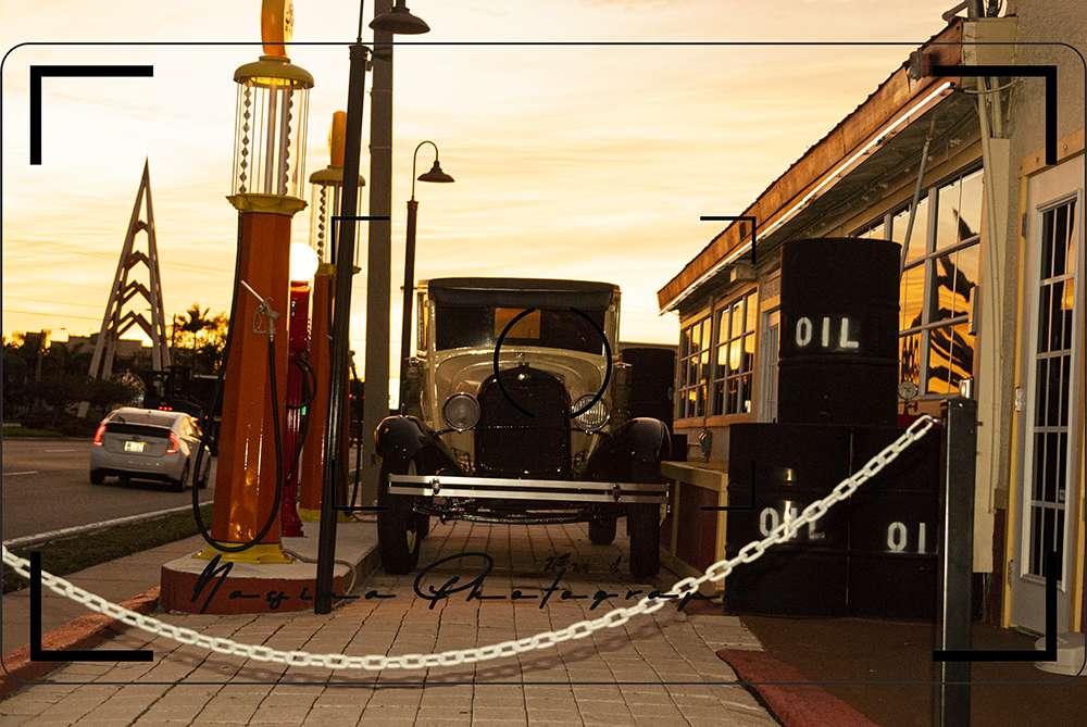 an old Ford at an antique gas station
