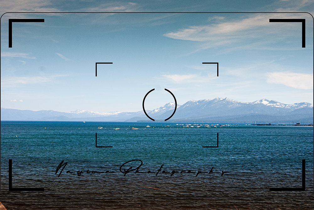view over Lake Tahoe with snowy mountains on the other side of the lake