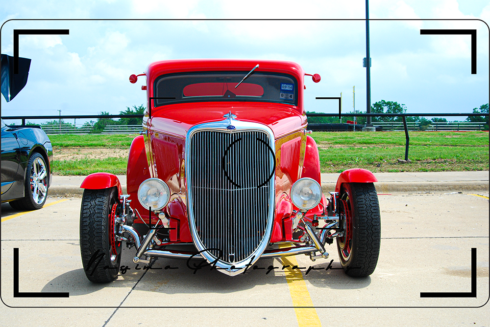 a red musclecar with a black grill in Burlington Texas